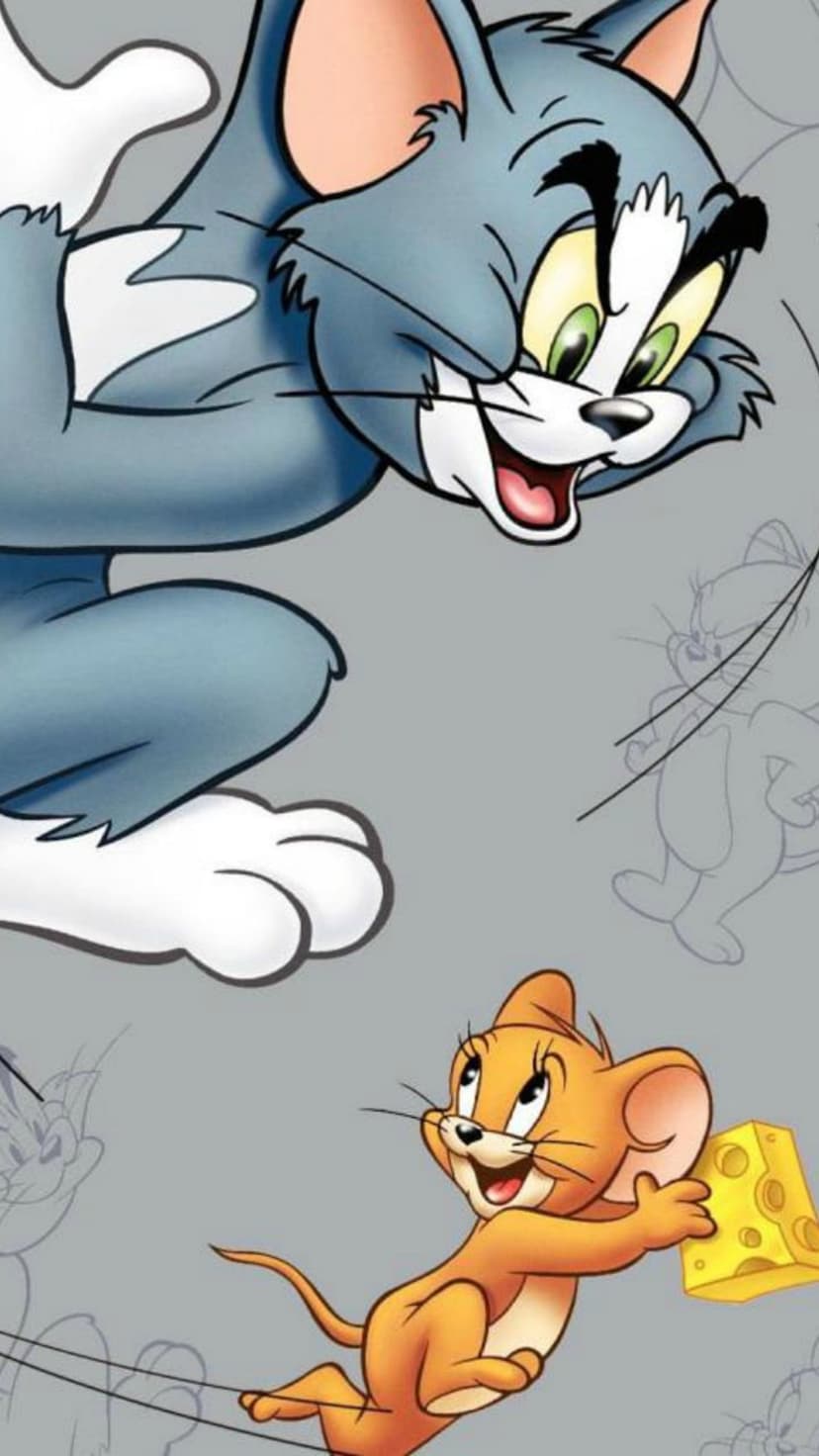 Tom the blue cat reaches for Jerry the orange mouse who is running away with a large slice of Swiss cheese.