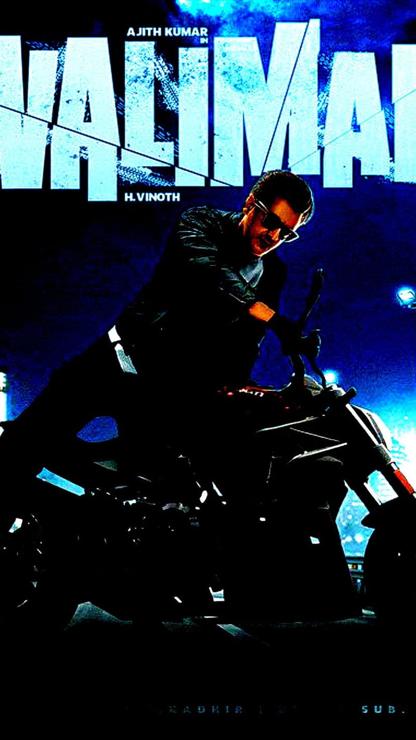 Ajith Kumar rides a motorcycle at high speed in an intense movie action scene with a blurred background.