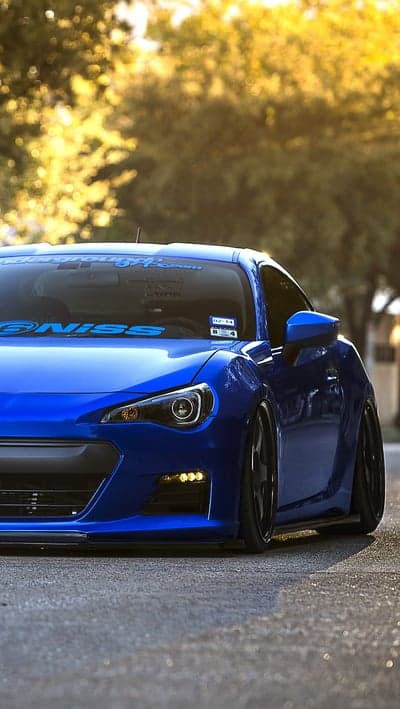 Vibrant blue custom sports car parked on asphalt
