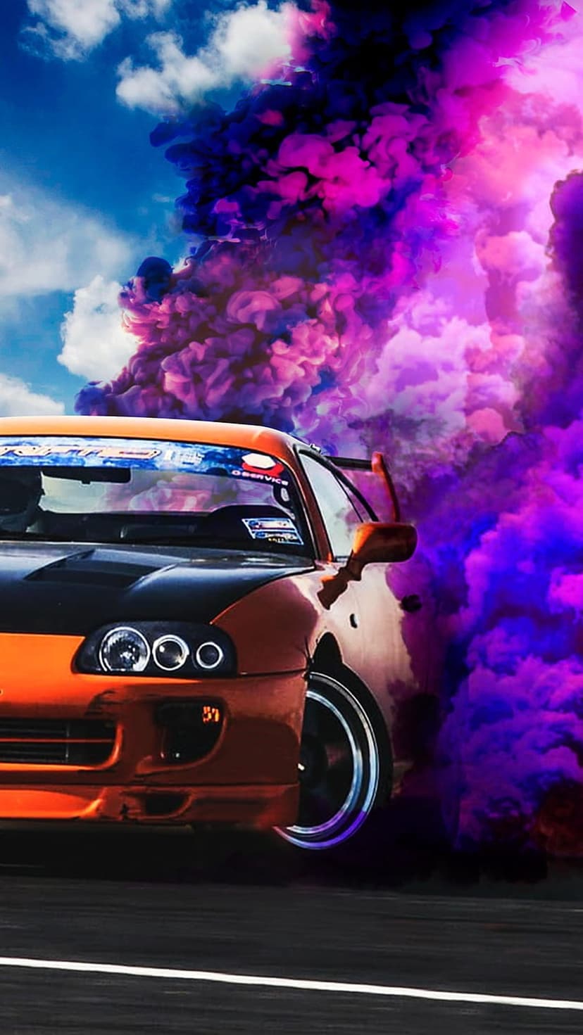Orange Toyota Supra drifting sideways through thick purple smoke clouds under a clear blue summer sky.