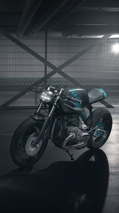 Dark Cafe Racer Motorcycle in Industrial Setting