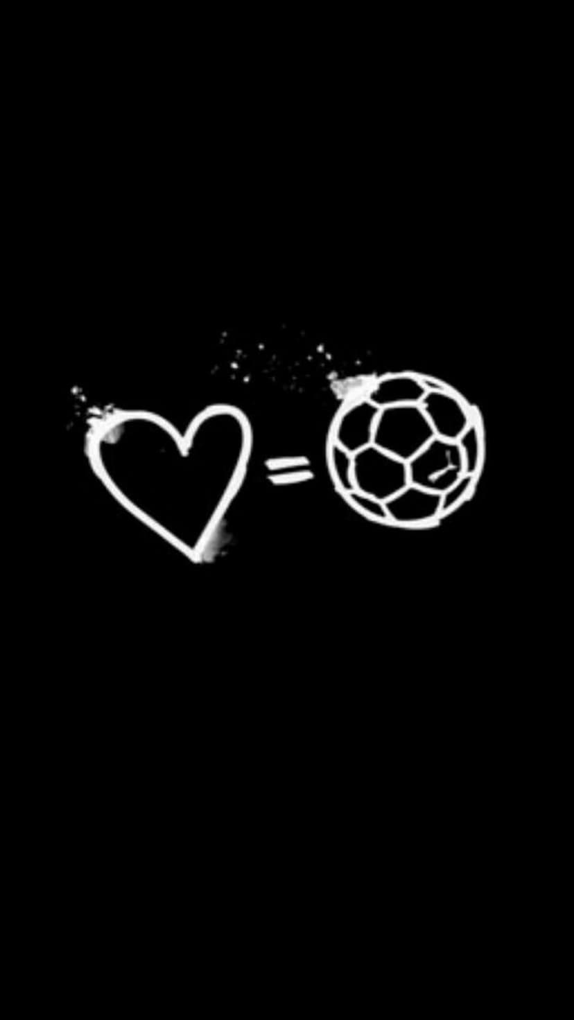 Soccer ball and heart icon hand-drawn in white chalk on a black background connected by an equals sign.