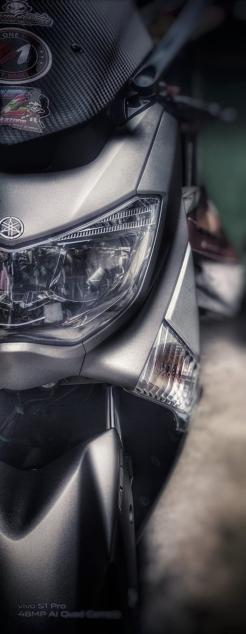 Silver Yamaha motorcycle headlight with matte grey bodywork, carbon fiber accents, and a brand logo badge.