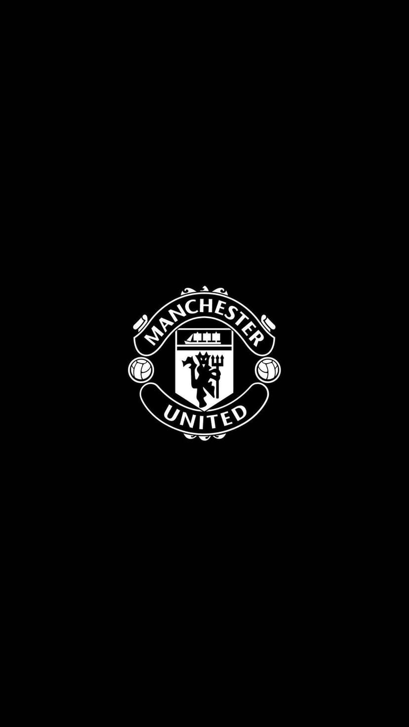 Manchester United white crest with a ship and devil symbol centered on a solid black vertical background.