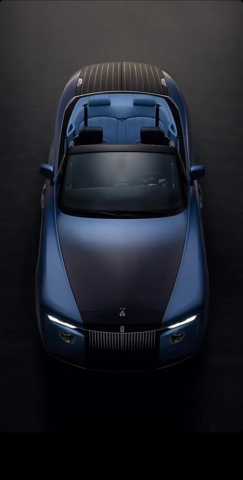 Rolls-Royce Boat Tail car features a blue finish and a wooden rear deck under soft, atmospheric lighting.