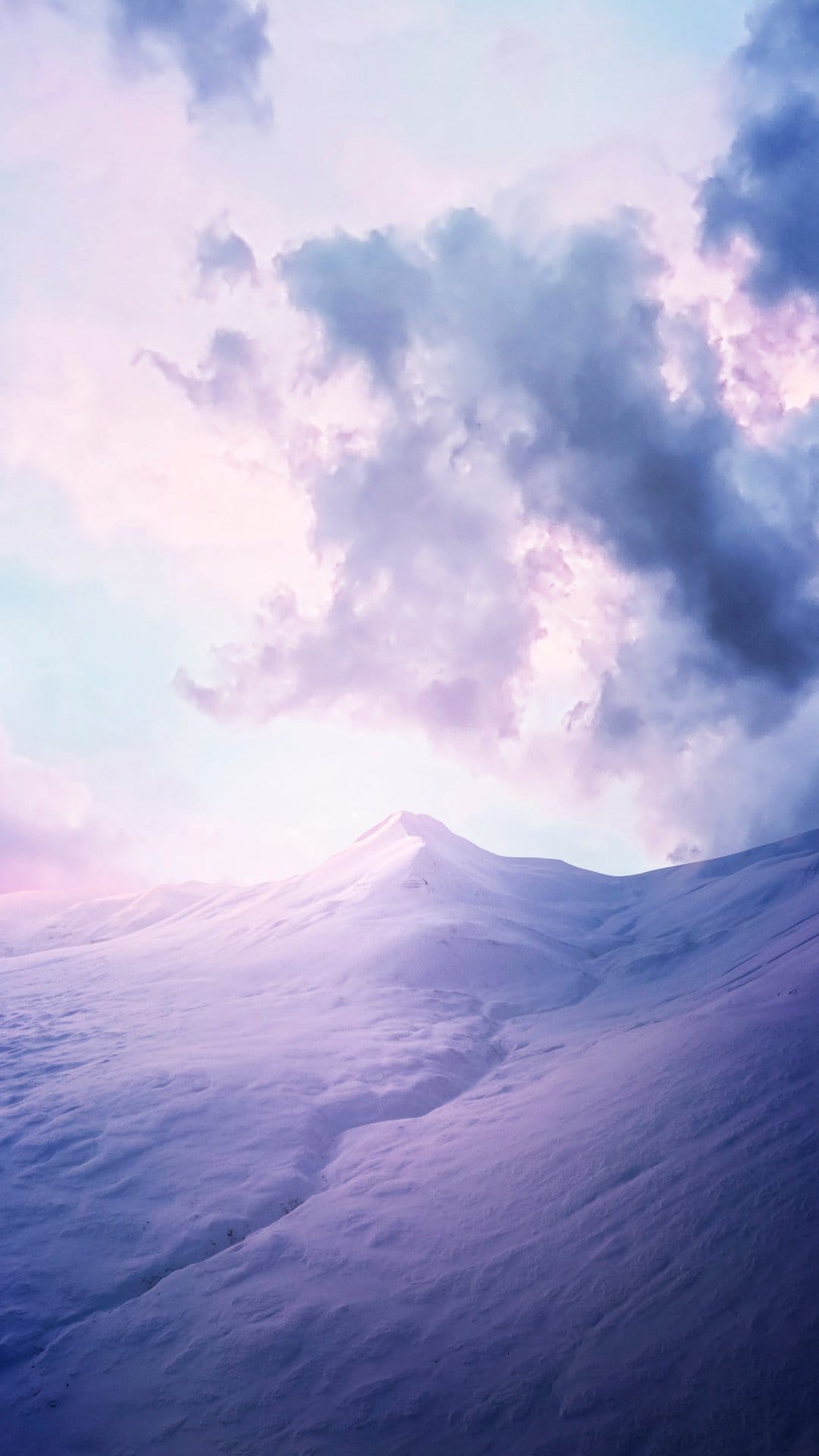 Snowy mountain peaks with a deep central crevice under a purple twilight sky filled with thick dramatic clouds.