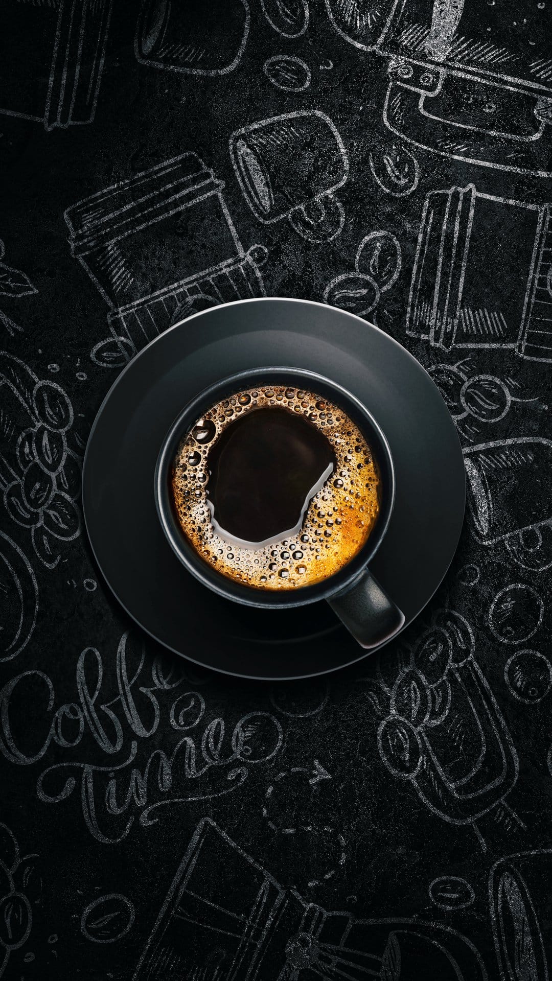 Black coffee mug with crema and rising steam resting on a saucer against a hand-drawn chalkboard background.
