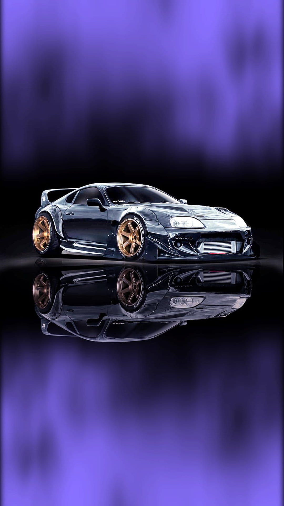 Toyota Supra with a widebody kit and gold rims reflected on a glossy surface against a vibrant purple background.