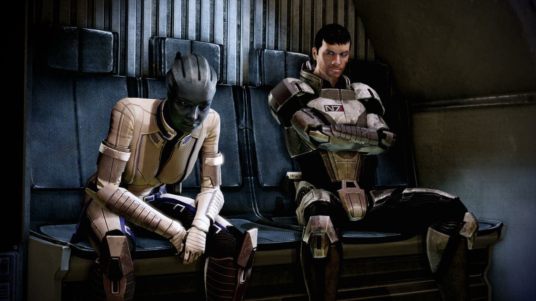 Commander Shepard in N7 armor and Liara T'Soni sit pensively inside a dark metallic shuttle interior.