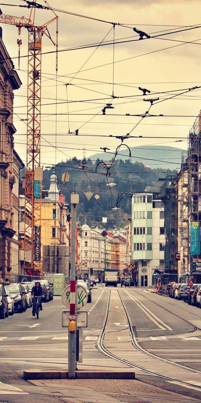 Innsbruck, Austria, urban, street, architecture, mountains, crane, travel, city, wires, classic buildings, bustling, scenic, European, cycling, industrial, cloudy sky, vibrant, road, historic, metropolitan