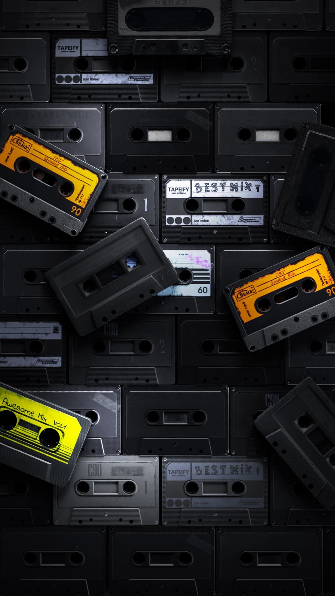 Vintage cassette tapes with colorful labels and plastic cases stacked together in a nostalgic music collection.