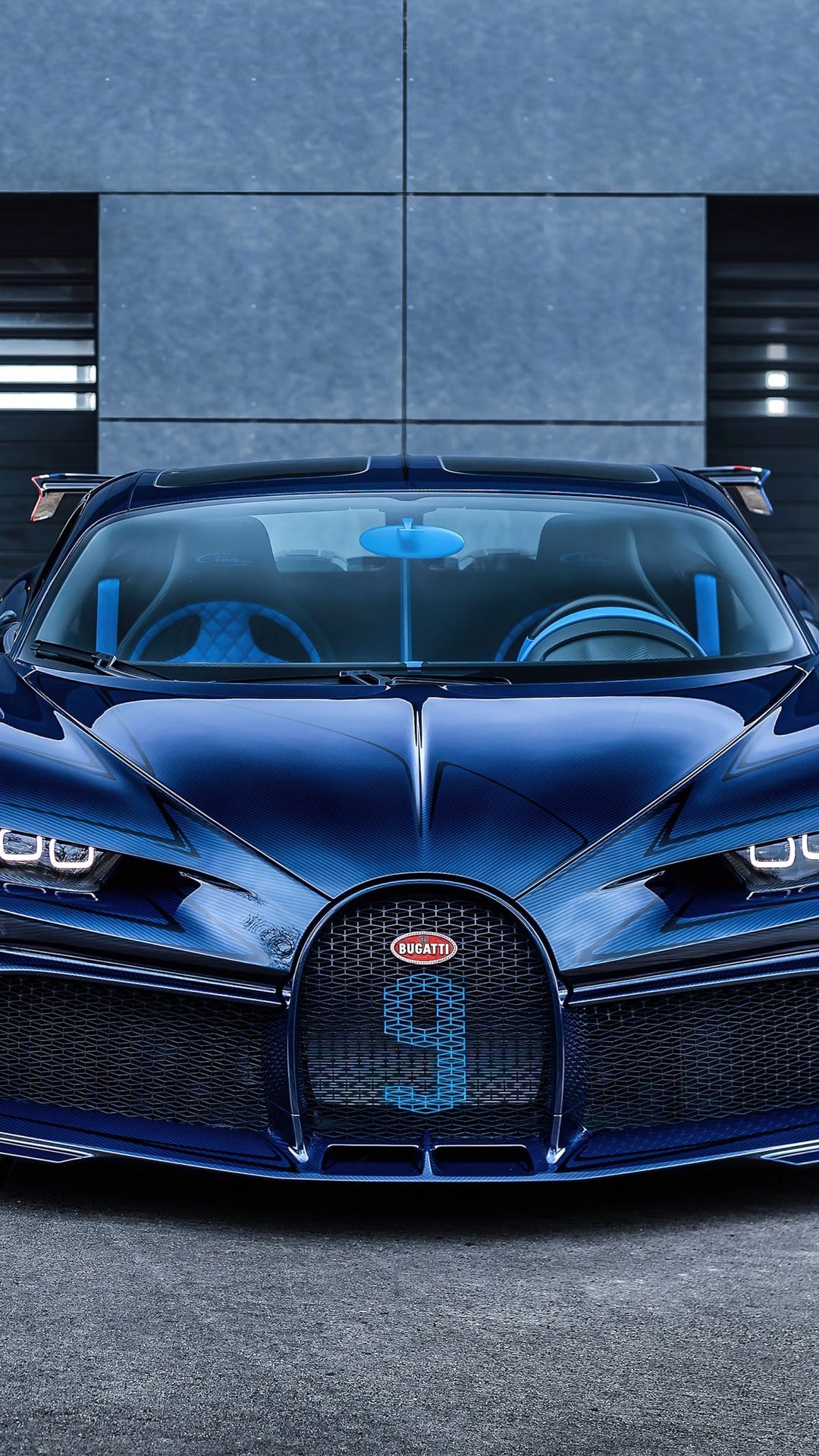 Dark blue Bugatti Chiron Pur Sport front view with carbon fiber body and blue number nine on the grille.