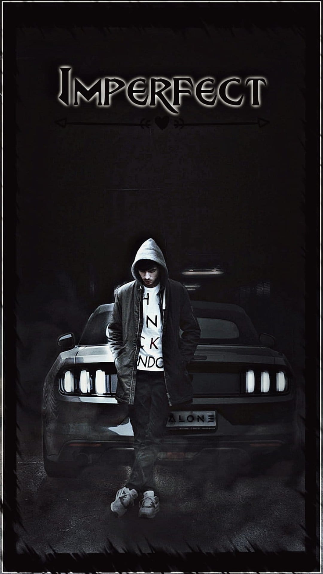 Young man in a hoodie leaning on a car with stylized Imperfect text above and an Alone license plate below.