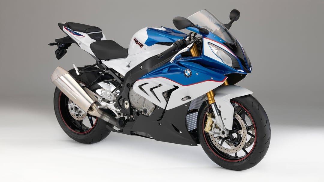 White and blue BMW S1000RR sportbike with red accents and gold forks showcased on a clean gray studio background.