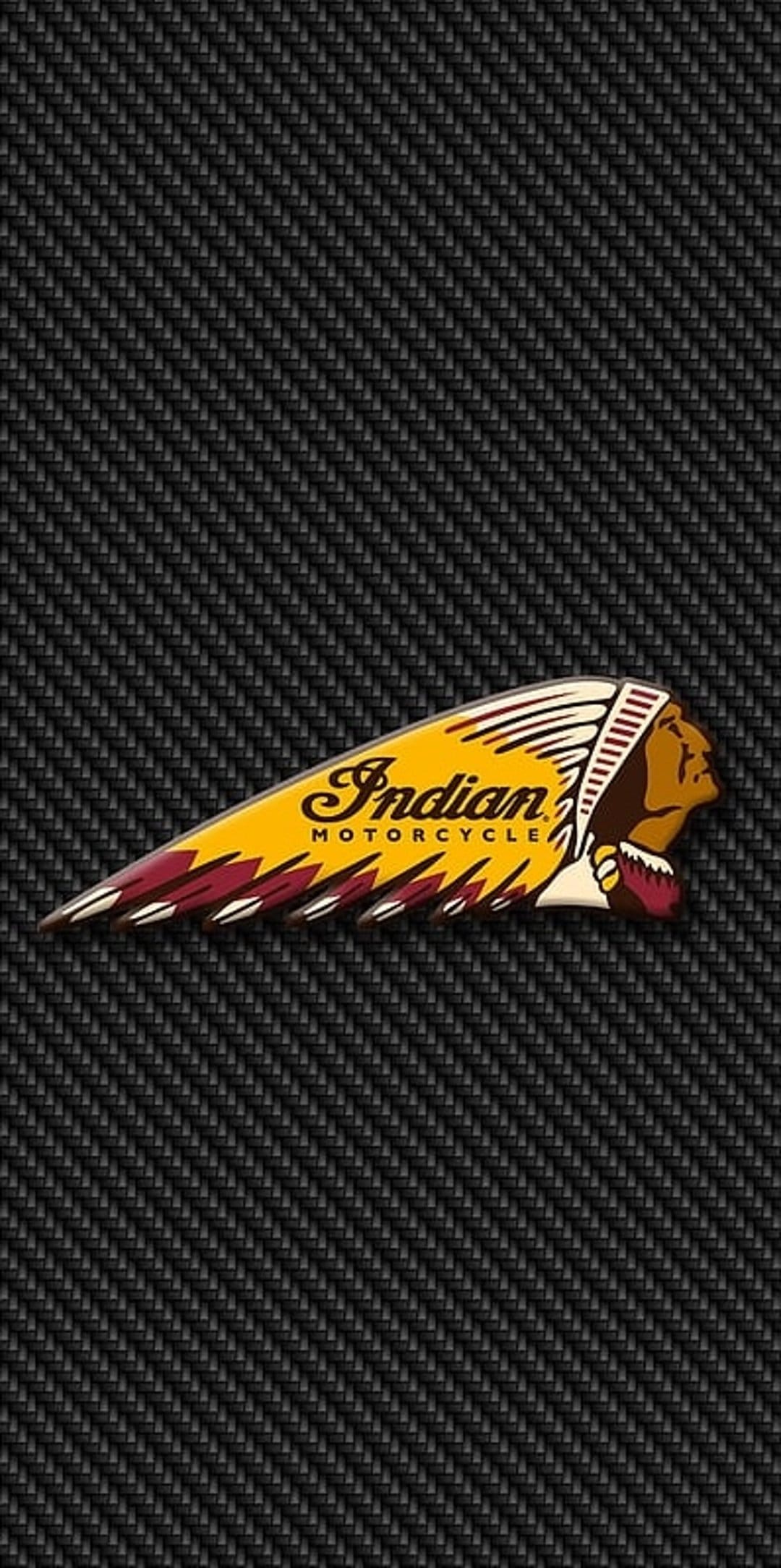 Indian Motorcycle headdress emblem with red and yellow feathers centered on a black woven carbon fiber surface.
