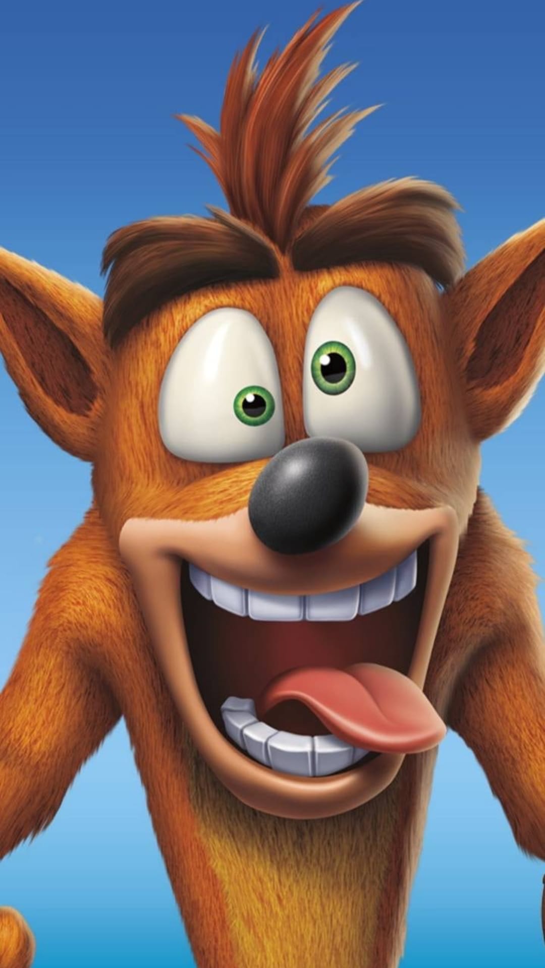 Crash Bandicoot grinning with his tongue out against a blue sky, featuring his orange fur and expressive eyes.