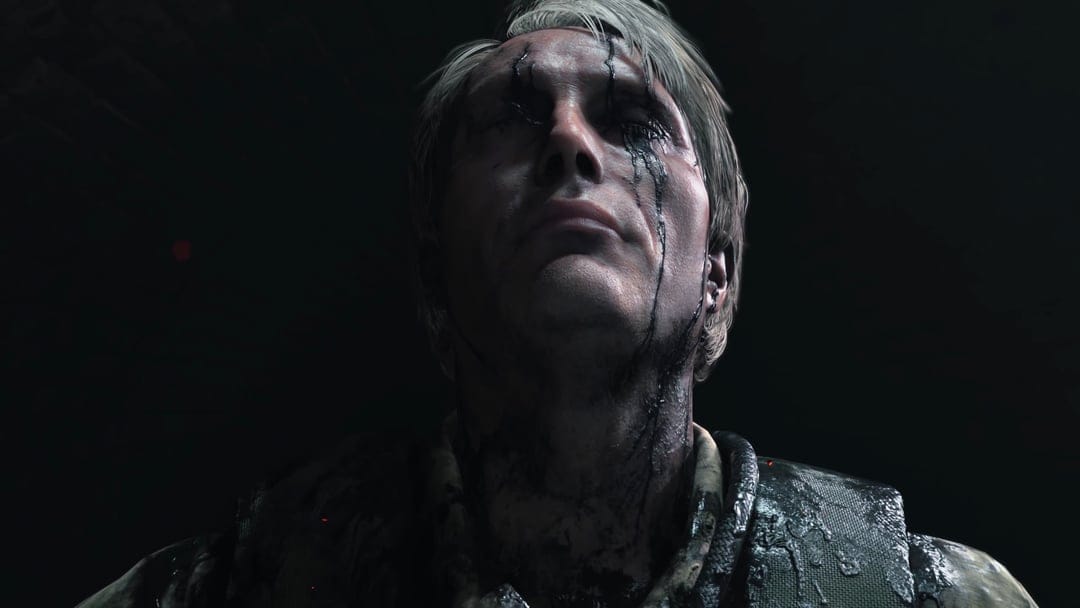 Man looking up with black oil dripping from his eyes wearing tactical gear in a dark, moody setting.