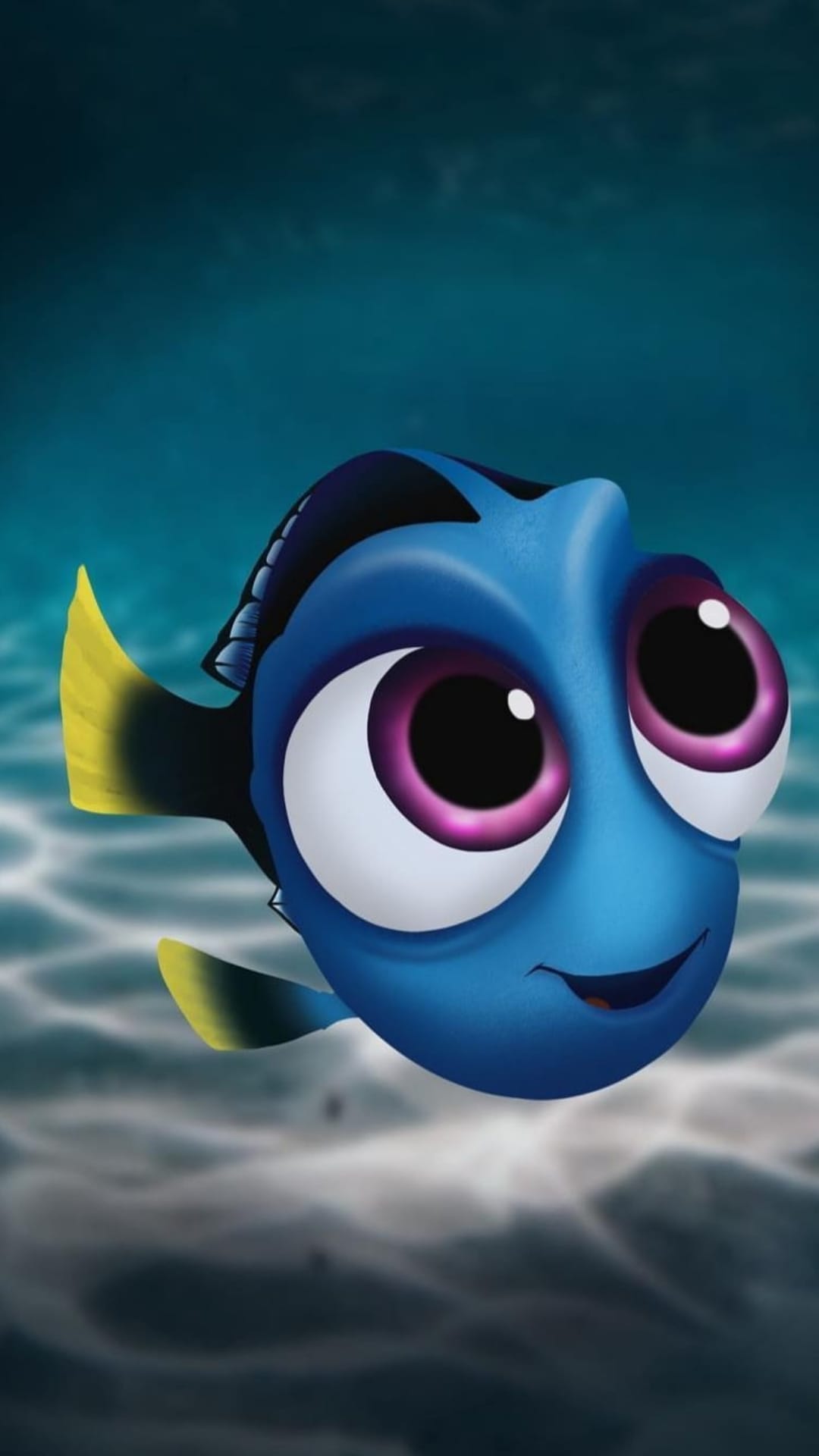 Dory the blue tang fish swims in a sunlit ocean with purple eyes, yellow fins, and a sandy seabed background.