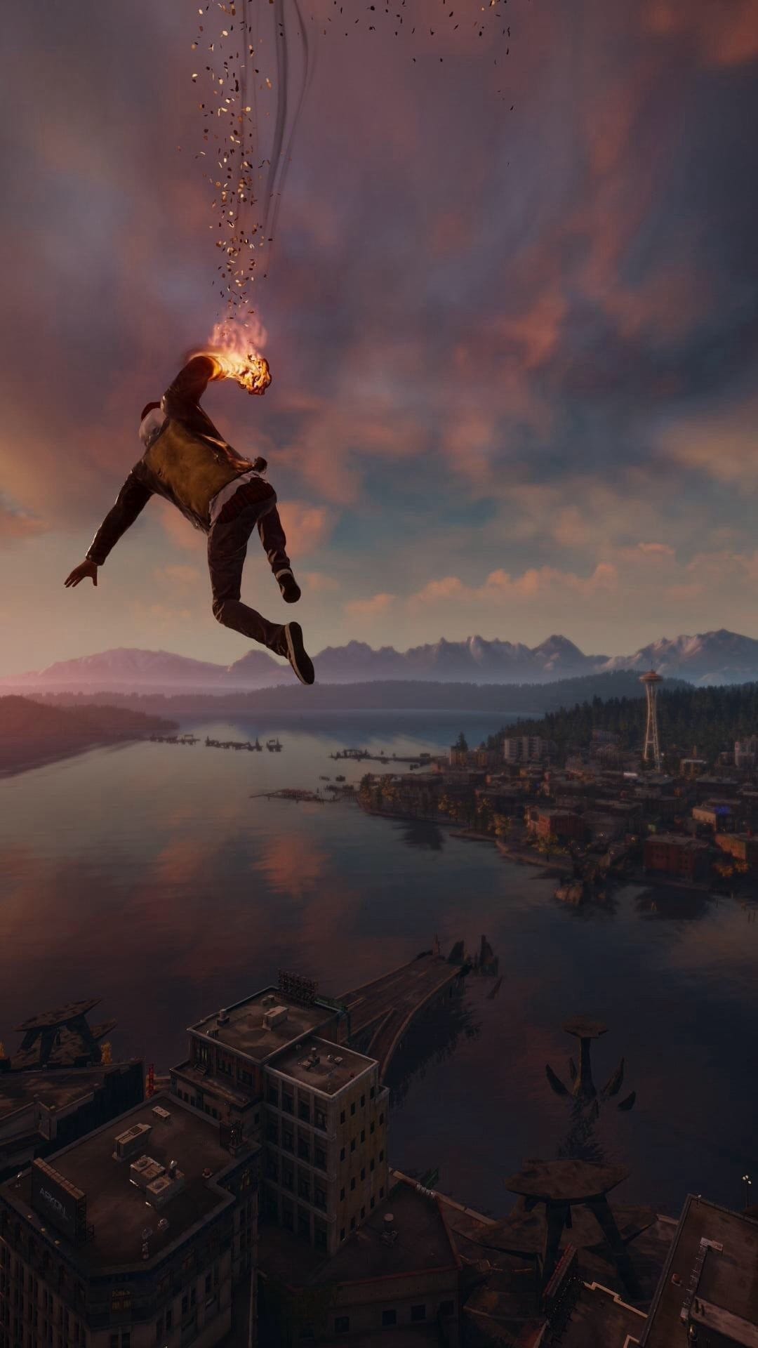 Delsin Rowe falling through a purple sunset sky over Seattle with glowing fire effects on his hand.