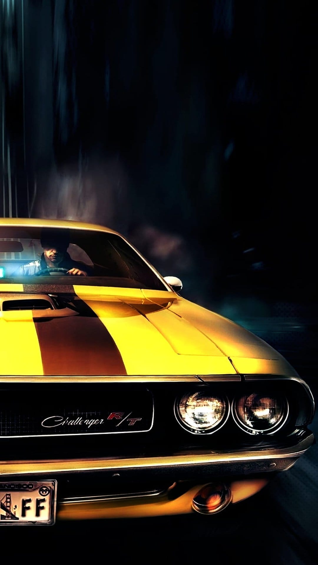 Yellow Dodge Challenger RT with black racing stripes and chrome accents parked in a dark, low-light setting.