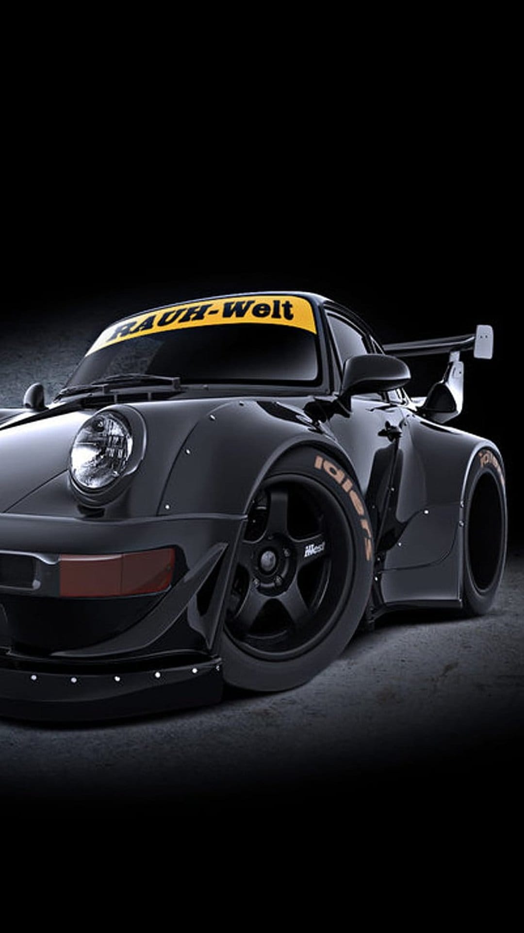 Black Porsche 911 RWB features widebody flares and a yellow windshield banner in a low-perspective view.