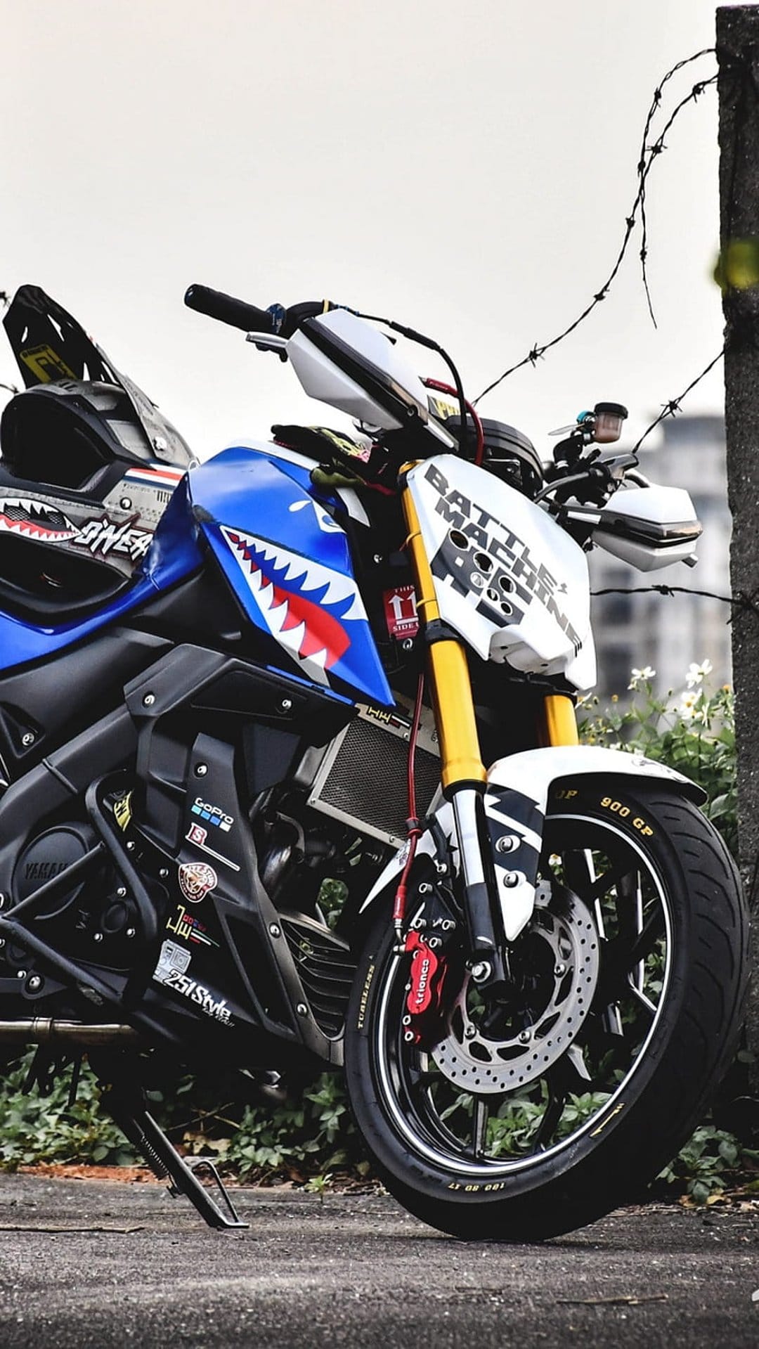 Yamaha sportbike with shark teeth graphics, yellow forks, and Battle Machine text on a white fairing.