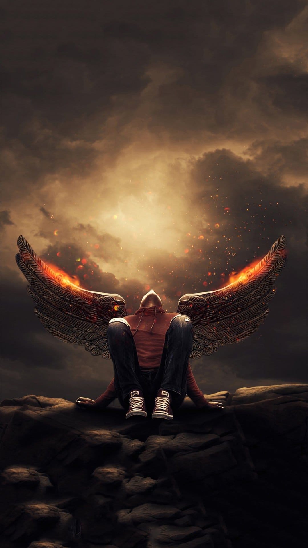 Hooded figure with large dark wings tipped in fire sits on a rock under a glowing orange and black sky.