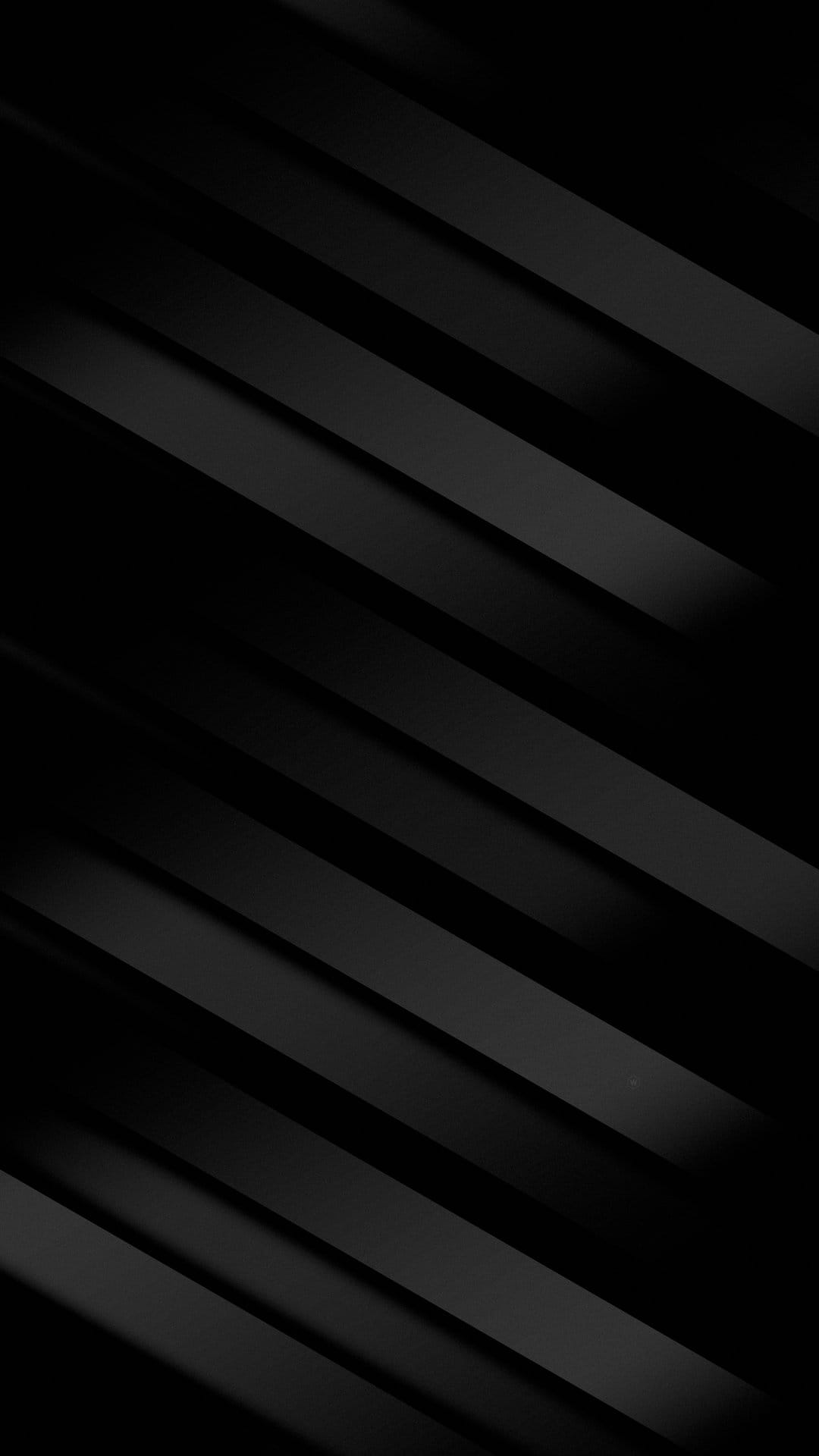 Dark grey parallel diagonal stripes with soft shadows and subtle lighting forming a textured 3D pattern.