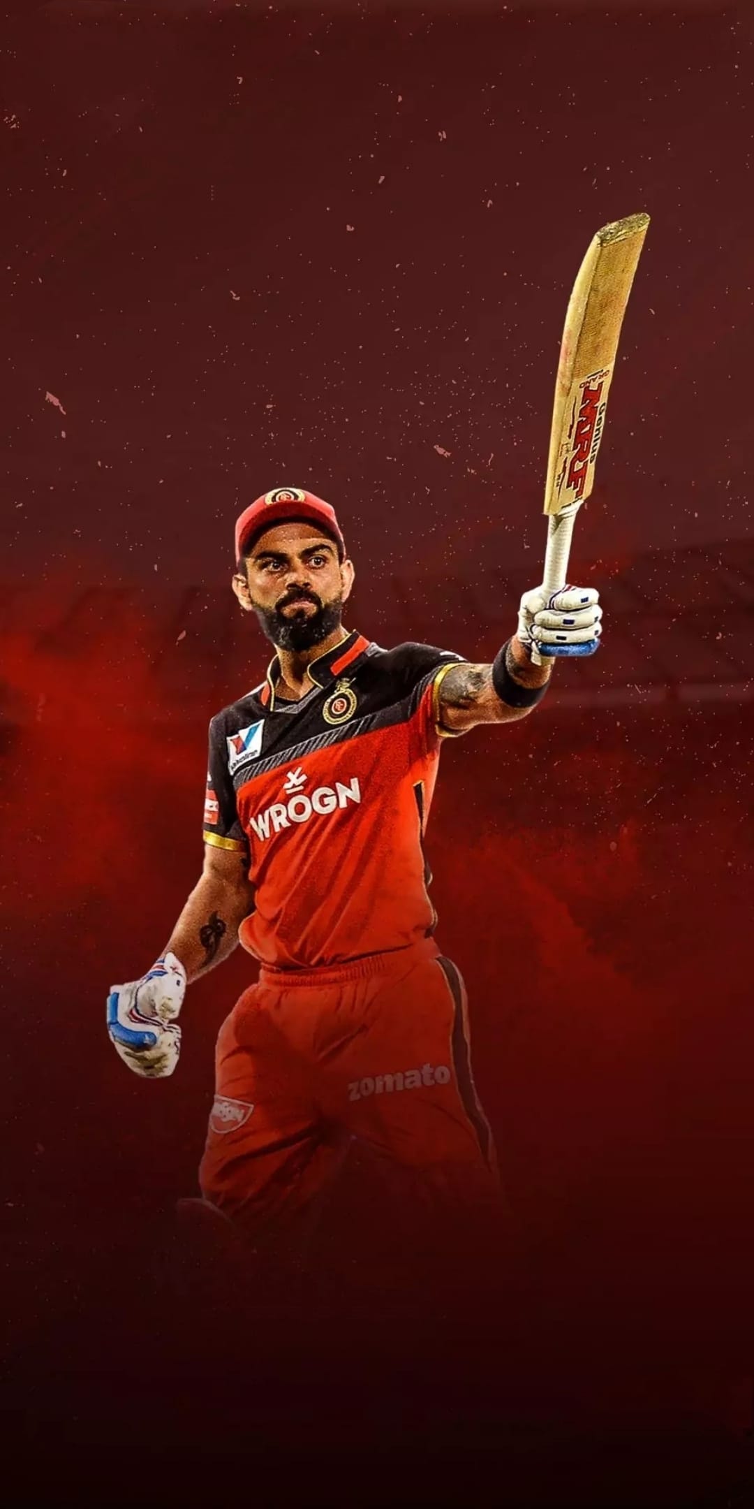Virat Kohli raises an MRF cricket bat while wearing a red Royal Challengers Bangalore jersey after a match win.