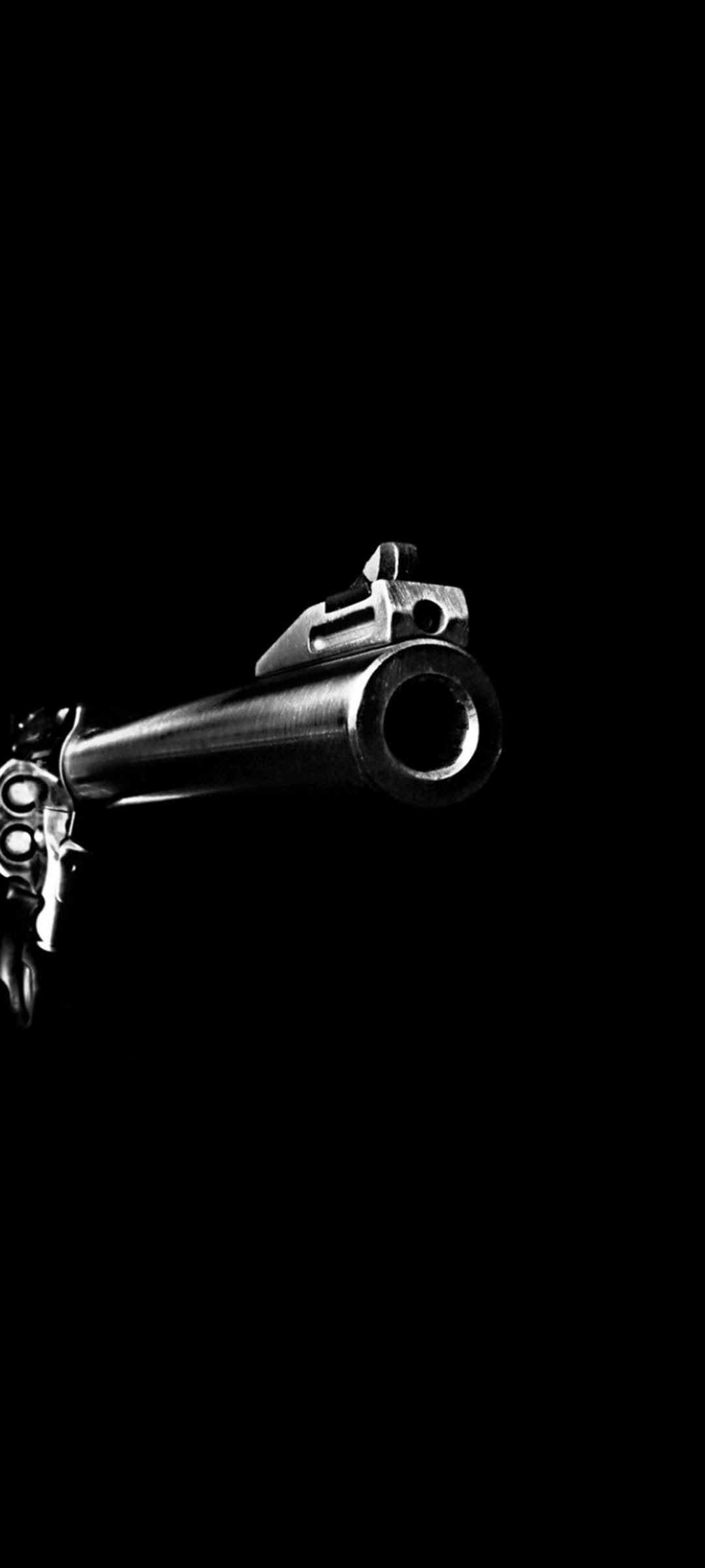 Revolver barrel and muzzle pointed forward with sharp metallic details in a high-contrast black and white style.