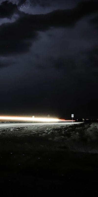 Night scene, Light trails, Long exposure, Dark sky, Urban night, Dynamic, Atmospheric, Blurry lights, Motion, Street photography, Stormy, Lightning, City at night, Abstract, Speed, Mood, Eerie, Cityscape, Night photography, Dark aesthetic