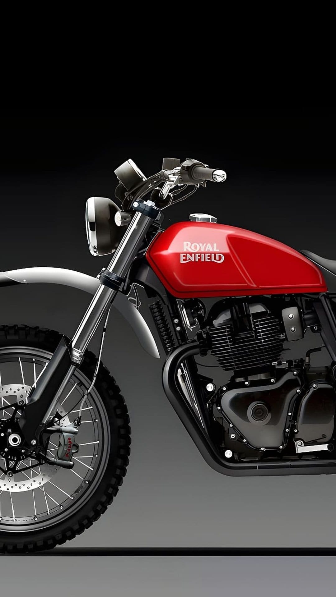 Royal Enfield motorcycle engine and front knobby tire with chrome details and a red fuel tank in a close-up view.