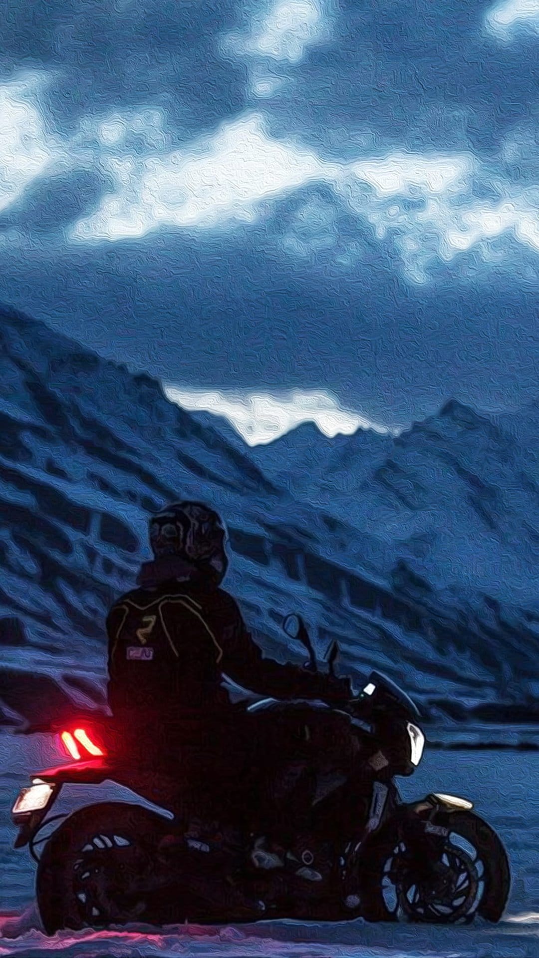Motorcyclist on a dark bike faces jagged snow-covered mountains under a heavy layer of dark, swirling clouds.