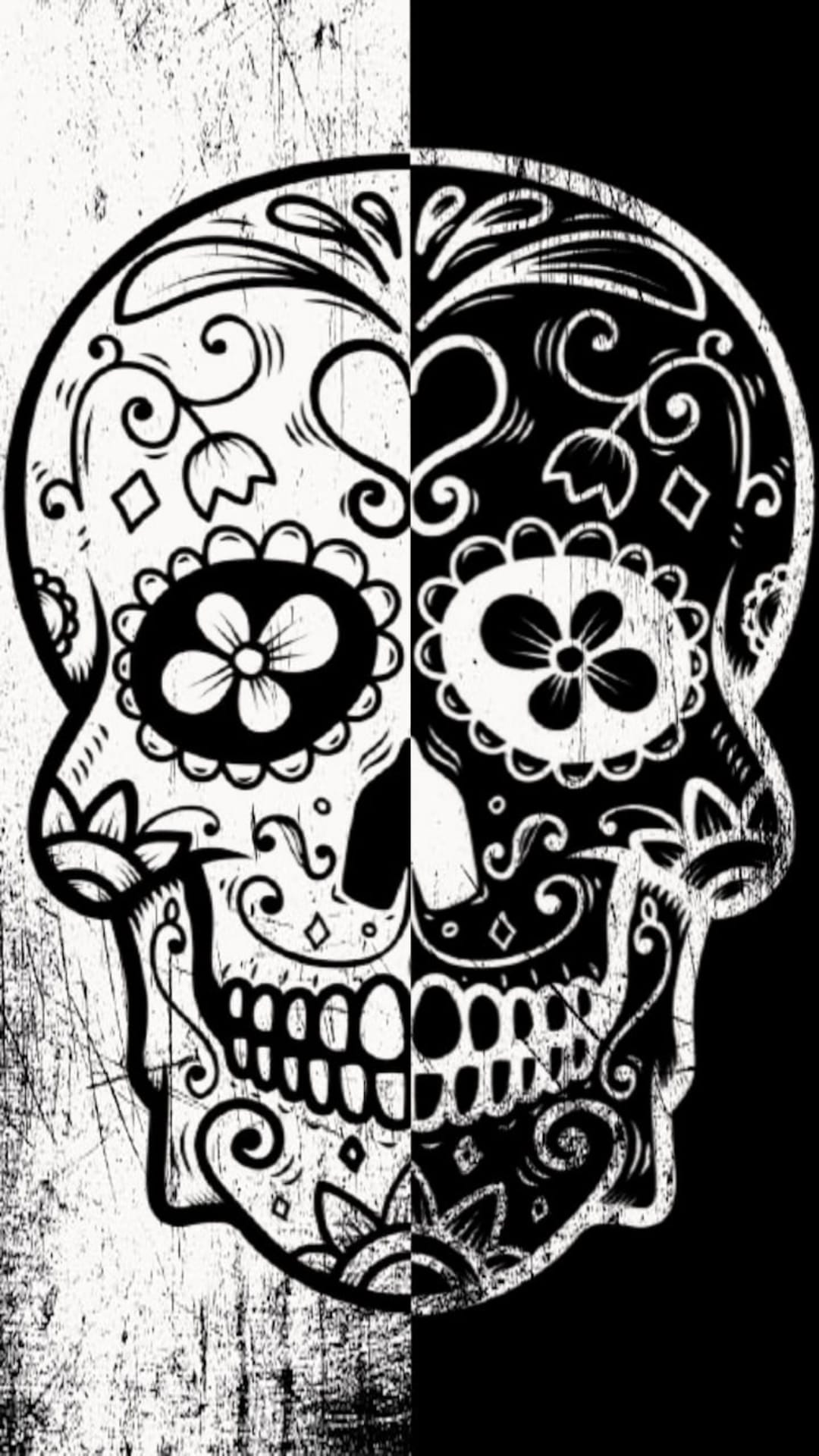 Ornate sugar skull split vertically with inverse black and white floral patterns and a distressed texture.