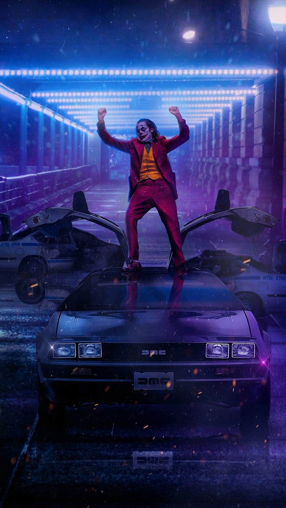 Joker stands on a DeLorean with arms raised under blue neon lights on a wet city street beside police vehicles.