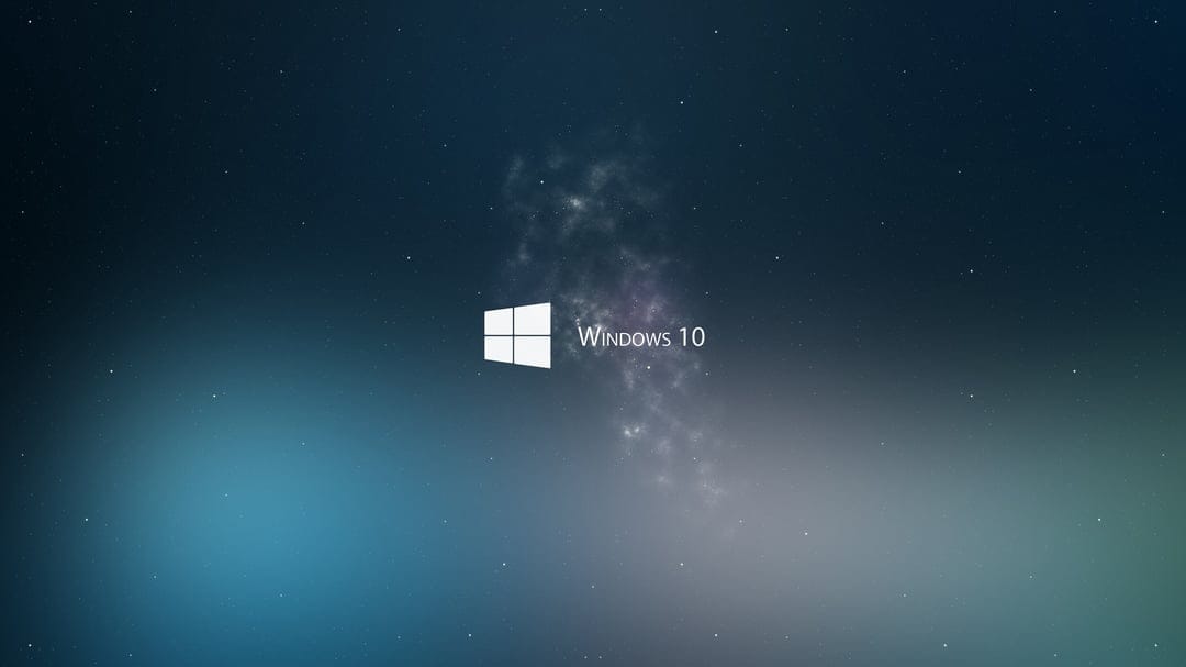 Windows 10 galaxy wallpaper showcasing a glowing blue logo amidst a vibrant cosmic nebula and digital stars.