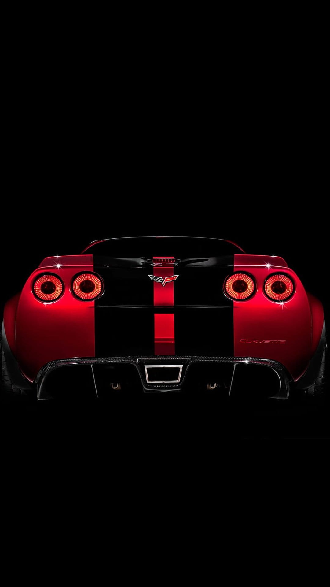 Chevrolet Corvette Z06 rear view featuring circular taillights, black racing stripes, and a wide rear diffuser.