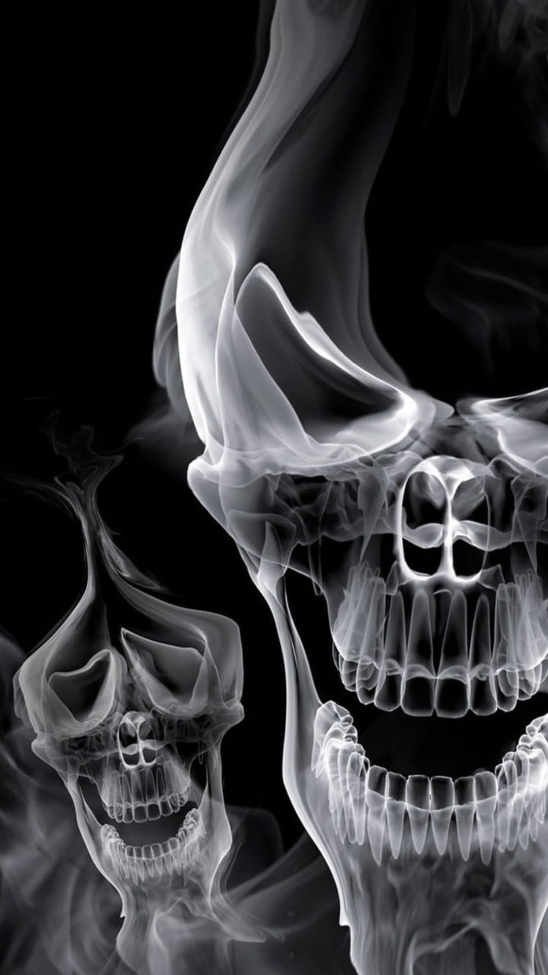 Two skulls formed from swirling white smoke with sharp teeth and dark eye sockets against a solid black background.