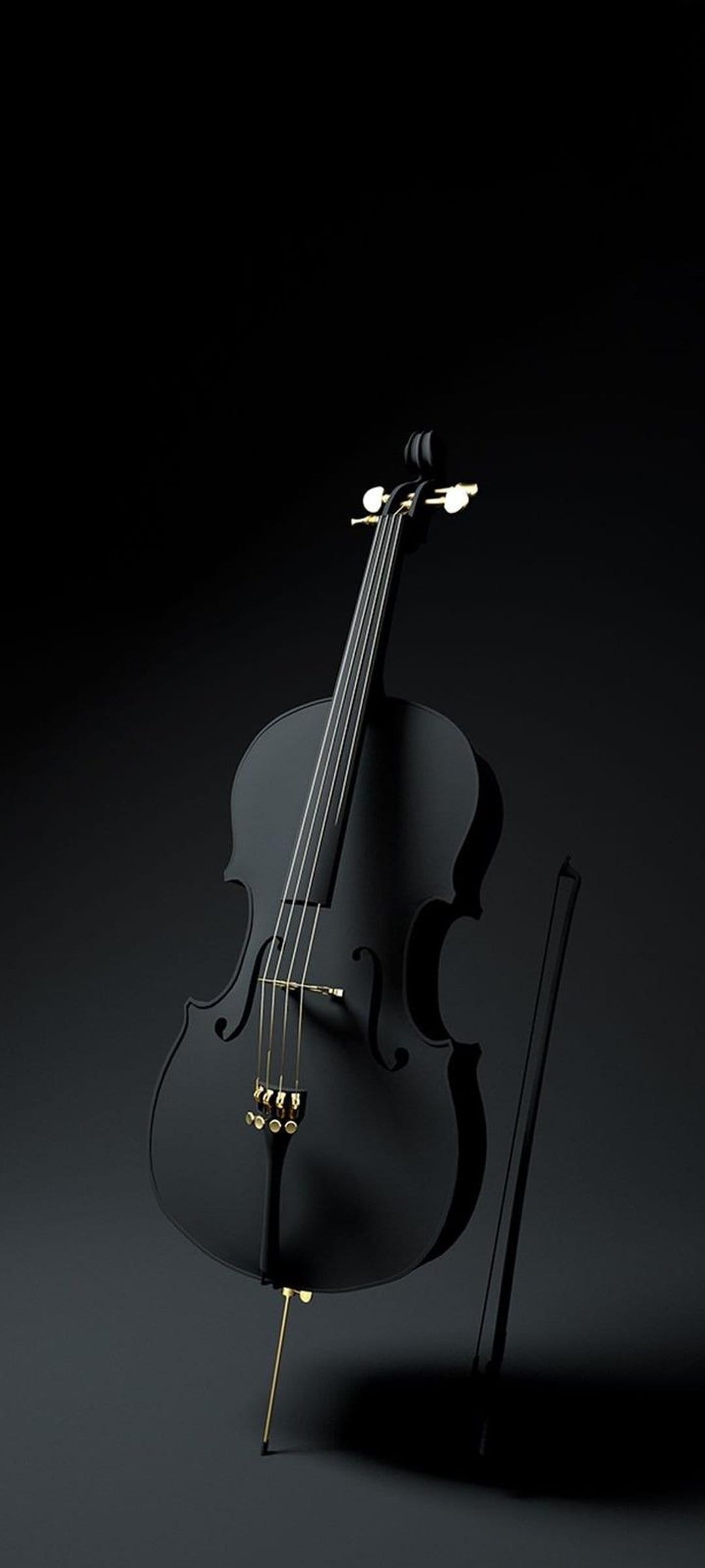 Black cello with gold tuning pegs and a vertical bow stands against a dark, minimalist studio background.