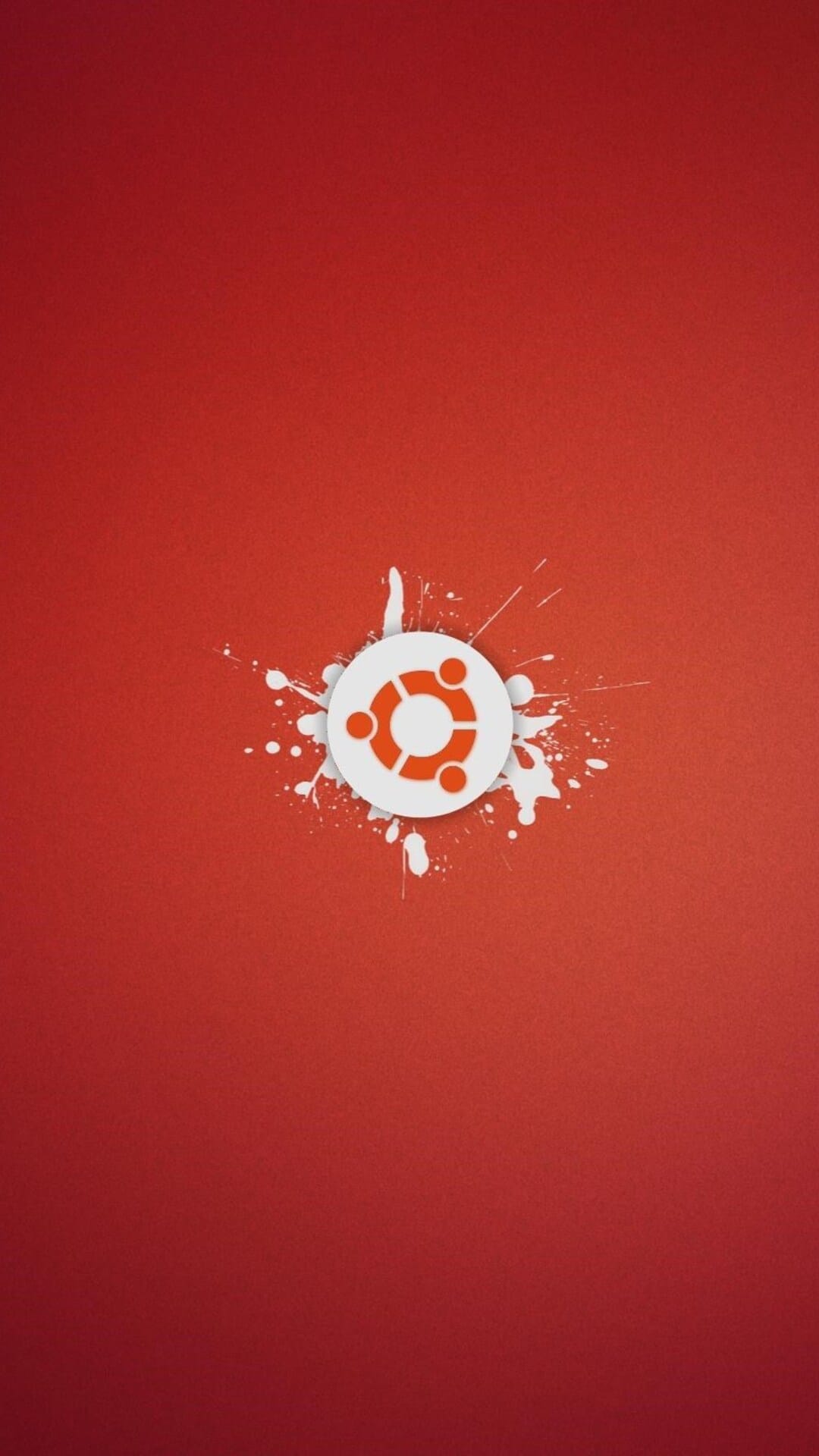 White Ubuntu logo sits centered amid radiating paint splatters on a gritty, deep red textured background.