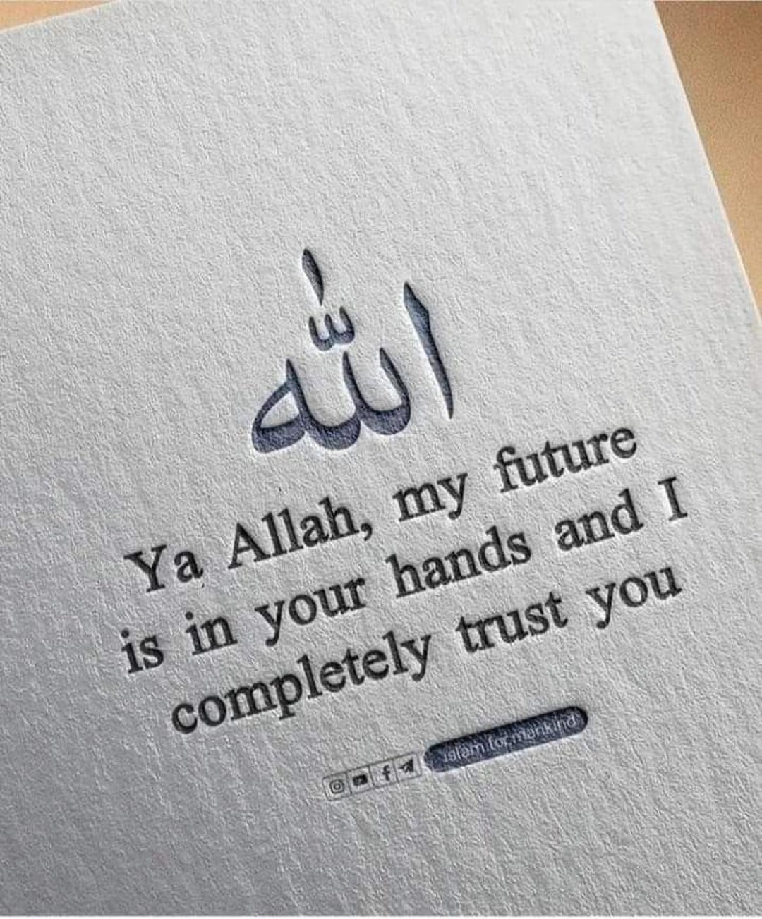Dark blue Arabic calligraphy and a prayer about trusting God are printed on a white textured paper background.