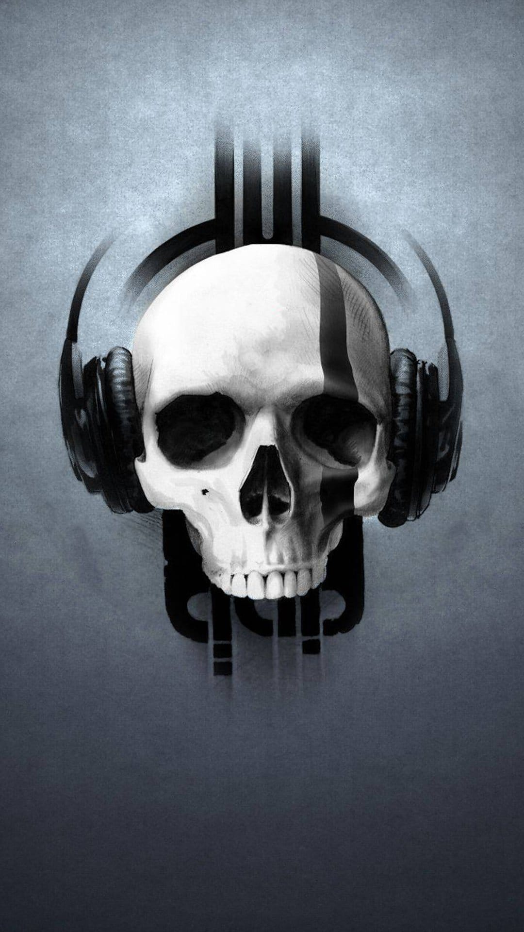 Human skull wearing audio headphones with a dark vertical forehead stripe against a mottled gray backdrop.