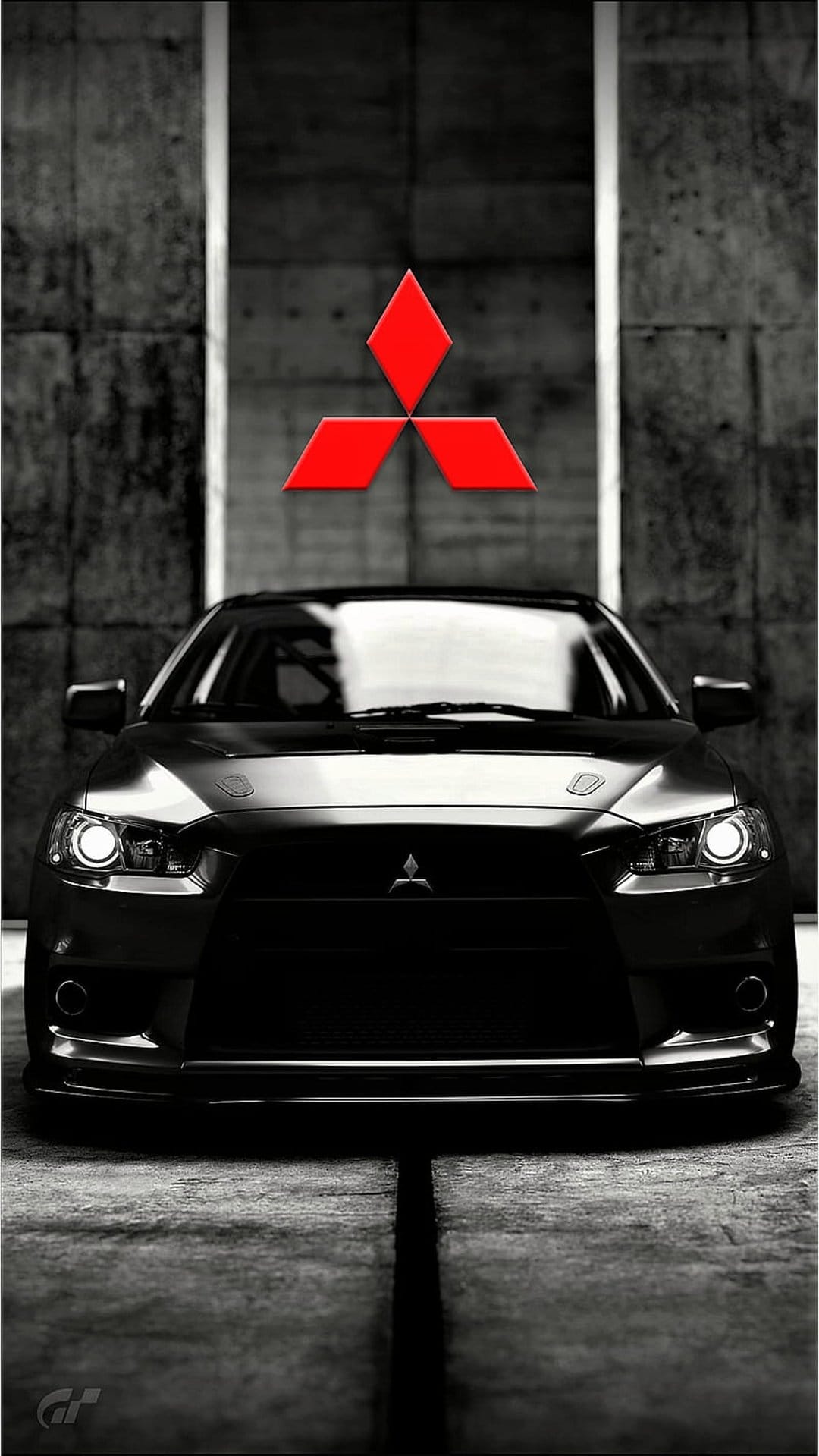 Black Mitsubishi Lancer Evolution parked on concrete with a red diamond logo and dramatic lighting shadows.
