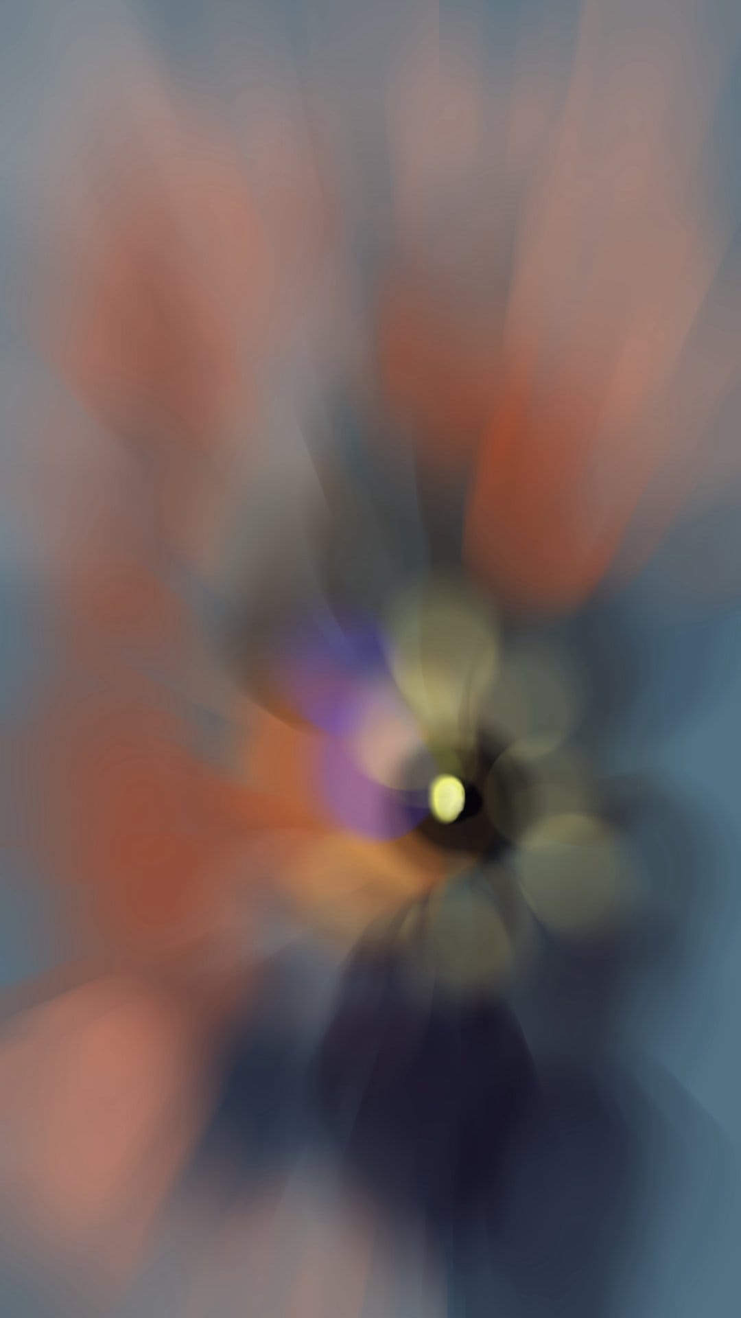 Swirling orange and blue light trails form a radial blur pattern with soft glowing bokeh circles throughout.