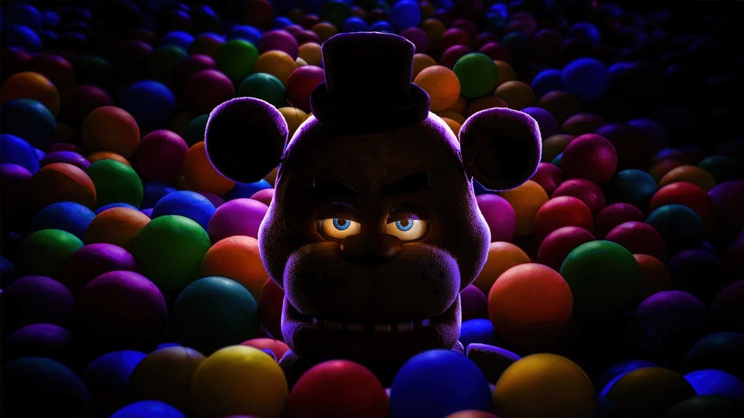 Freddy Fazbear animatronic head shows weathered brown fur and glowing eyes against a dark atmospheric background.