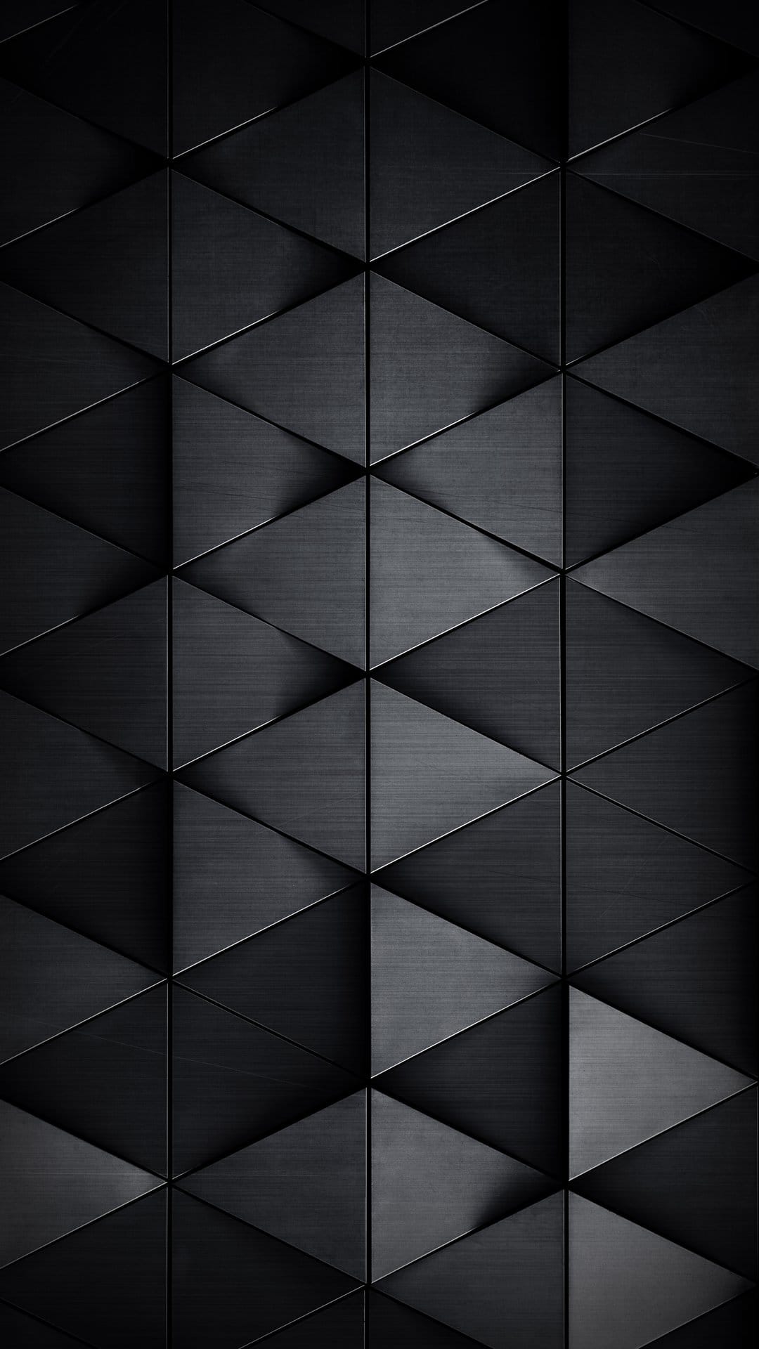 Charcoal gray triangles with brushed metal surfaces overlap to create a three-dimensional geometric pattern.
