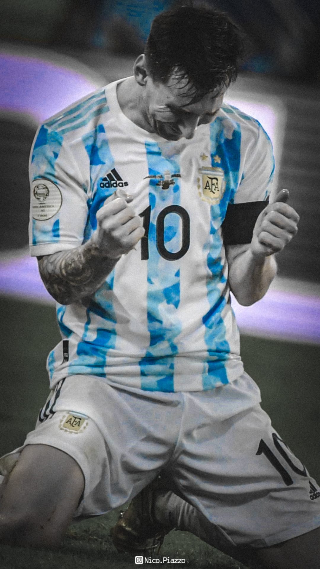Lionel Messi kneels with clenched fists in a blue and white Argentina jersey during a jubilant goal celebration.
