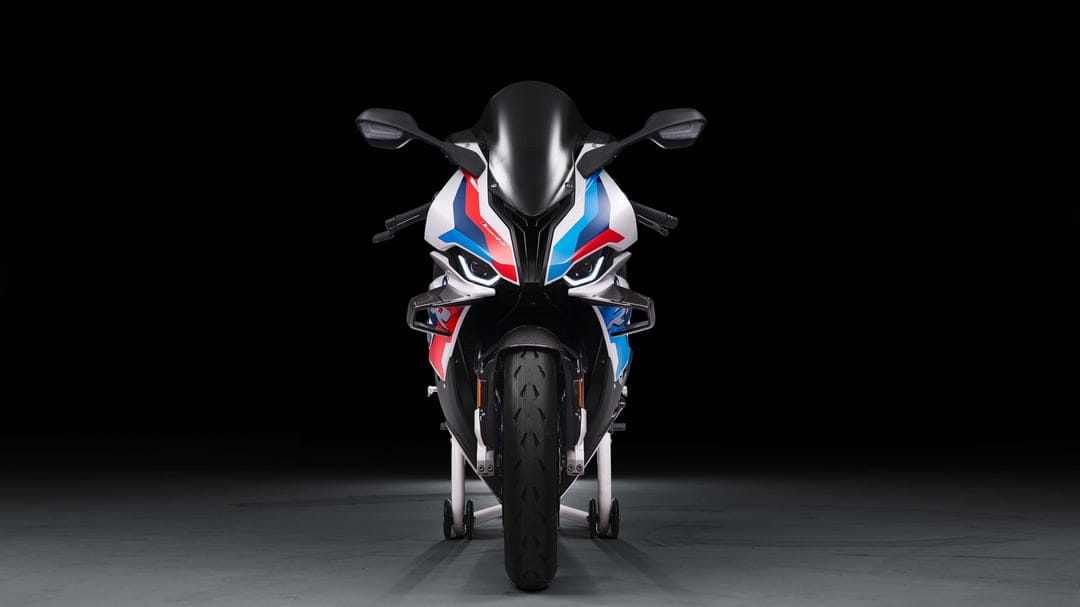 BMW M 1000 RR sportbike front view featuring aerodynamic winglets and tri-color livery on a dark background.