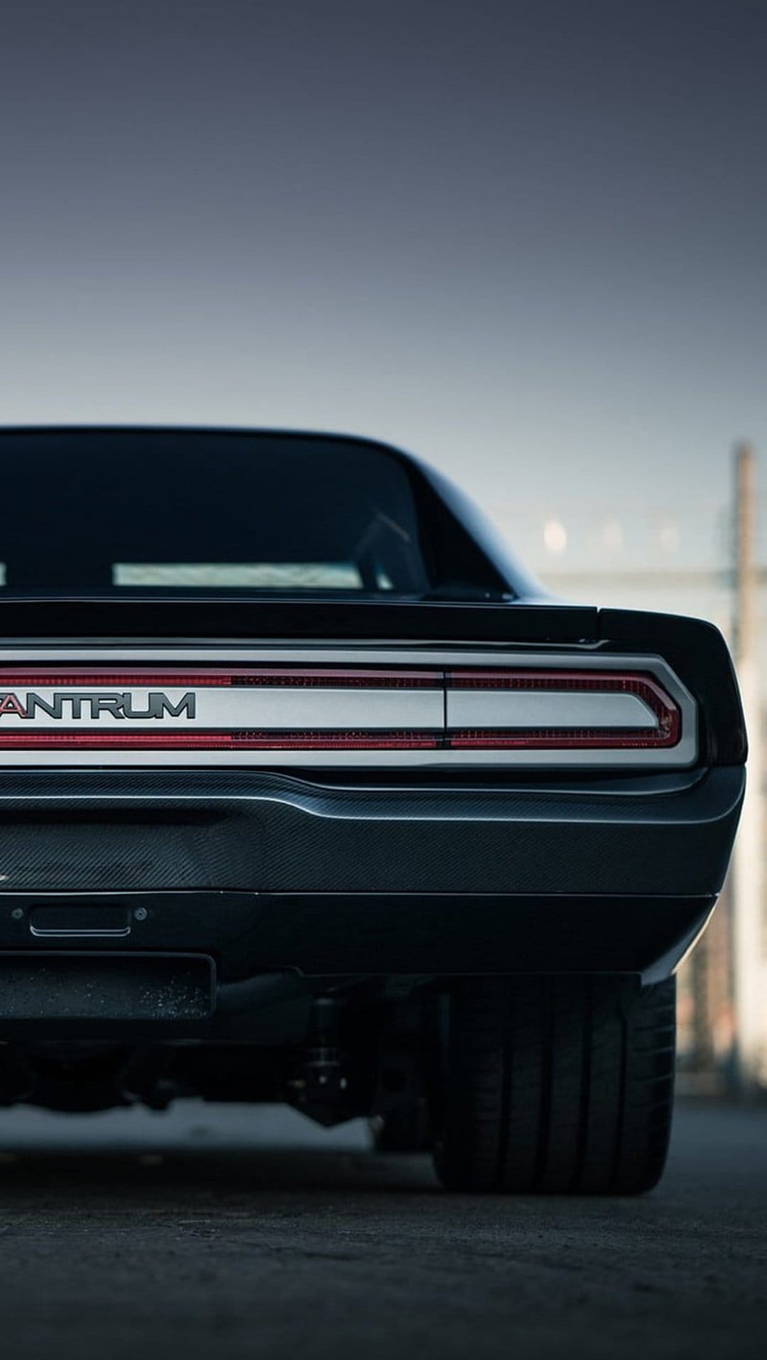 Dodge Challenger Antrum rear view featuring a full-width LED light bar, carbon fiber, and a wide performance tire.