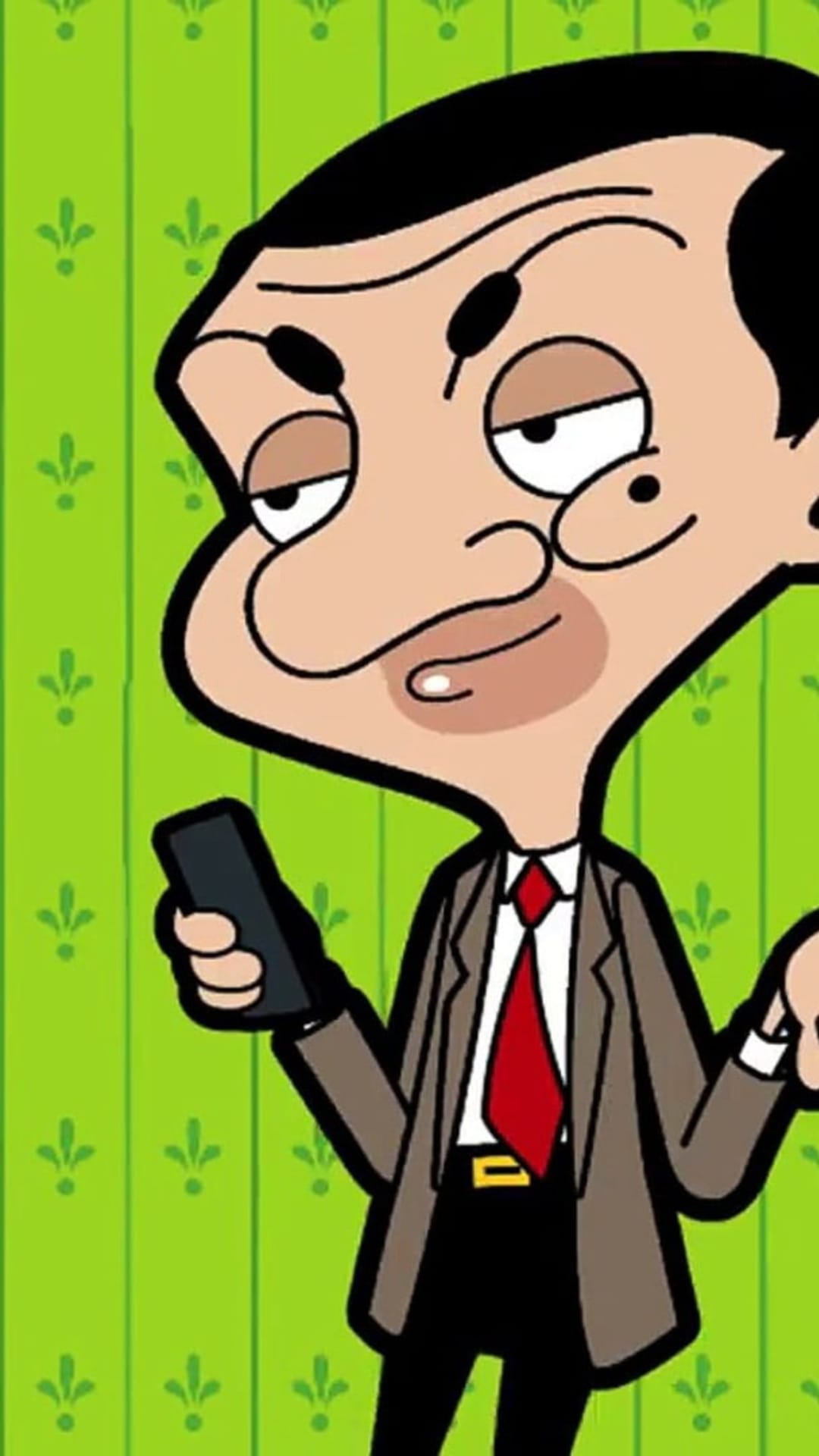 Mr. Bean holding a smartphone wearing a brown suit and red tie against a green floral patterned background.